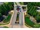 Stunning gated entrance with ponds, waterfalls, lush landscaping, and a charming gate house at 2360 Braunsroth Ln, Hampton, GA 30228
