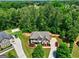 Beautiful gray home with a stone facade, mature landscaping, and a curved driveway at 2360 Braunsroth Ln, Hampton, GA 30228