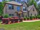 Beautiful brick home featuring manicured landscaping and a well-maintained lawn at 2360 Braunsroth Ln, Hampton, GA 30228