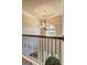 Upstairs hallway featuring iron railing, overhead lighting, and architectural detail at 2360 Braunsroth Ln, Hampton, GA 30228