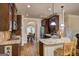 Modern kitchen with granite countertops, stainless steel appliances, and dark wood cabinets at 2360 Braunsroth Ln, Hampton, GA 30228