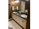 Bathroom with double sink vanity, white cabinets, and modern fixtures at 187 Pine Branch Dr, Stockbridge, GA 30281