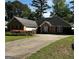 Charming brick home featuring a driveway, attached garage, and blooming shrubbery, creating a welcoming facade at 187 Pine Branch Dr, Stockbridge, GA 30281