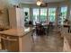 Bright kitchen with granite counters, stainless steel appliances, and eat-in area surrounded by large windows at 187 Pine Branch Dr, Stockbridge, GA 30281