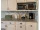 Bright kitchen features granite counters, white cabinetry, and modern appliances at 187 Pine Branch Dr, Stockbridge, GA 30281