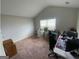 A bedroom with carpet, light walls, and a small desk at 5470 Hilltop Pass, Fairburn, GA 30213