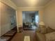 Elegant dining room with stylish furniture and a view into the living room and hallway at 5470 Hilltop Pass, Fairburn, GA 30213
