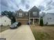 Charming two-story home with a two-car garage, lovely yard, and well-maintained landscaping at 5470 Hilltop Pass, Fairburn, GA 30213
