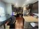 Modern kitchen with dark wood cabinets, stainless steel appliances, and granite countertops at 5470 Hilltop Pass, Fairburn, GA 30213