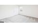 Bedroom with carpeted floor and a large window offering lots of natural light at 303 Limestone Circle, Conyers, GA 30013