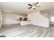 Bright open-concept living room with gray floors and a view into the kitchen at 303 Limestone Circle, Conyers, GA 30013