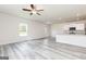 Open-concept living room with gray flooring flowing into the kitchen area at 303 Limestone Circle, Conyers, GA 30013