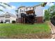 Backyard view of a two-story home featuring a brick foundation, deck, and well-manicured lawn at 2100 Willshire Gln, Alpharetta, GA 30009