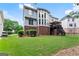 A well-maintained backyard featuring lush green grass, attractive landscaping, and a wooden deck at 2100 Willshire Gln, Alpharetta, GA 30009