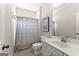 Cozy bathroom featuring a shower with a neutral striped curtain, white vanity, and tile flooring at 2100 Willshire Gln, Alpharetta, GA 30009