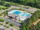 A bird's eye view of the community pool and splash pad surrounded by mature shade trees at 2100 Willshire Gln, Alpharetta, GA 30009