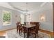 Elegant dining room with tray ceiling, classic wainscoting, decorative niches and chandelier at 2100 Willshire Gln, Alpharetta, GA 30009