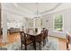 Bright dining room showcasing hardwood floors, modern chandelier, and a view into the adjacent living area at 2100 Willshire Gln, Alpharetta, GA 30009