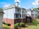 Rear view of a two-story home featuring a brick foundation, deck, and well-manicured lawn at 2100 Willshire Gln, Alpharetta, GA 30009