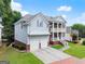 Beautiful home showcasing a side view with a two-car garage, manicured lawn, and classic architectural details at 2100 Willshire Gln, Alpharetta, GA 30009