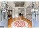 Elegant foyer featuring hardwood floors, high ceilings, decorative rug, and a view of the upper level at 2100 Willshire Gln, Alpharetta, GA 30009
