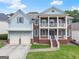 Charming two-story home features a brick and siding exterior, inviting front porch, and well-maintained landscaping at 2100 Willshire Gln, Alpharetta, GA 30009