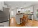 Bright kitchen featuring a breakfast bar, stainless steel appliances, white cabinetry, and hardwood floors at 2100 Willshire Gln, Alpharetta, GA 30009