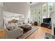 Spacious living room features a fireplace, lots of windows, and an open concept design to the kitchen at 2100 Willshire Gln, Alpharetta, GA 30009