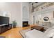 Cozy living room with fireplace, soaring windows, and comfortable seating. Overlooks second-story balcony at 2100 Willshire Gln, Alpharetta, GA 30009