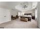 Spacious main bedroom with a tray ceiling, ceiling fan, sitting area, and a luxurious ensuite bathroom at 2100 Willshire Gln, Alpharetta, GA 30009