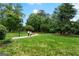 Serene park with winding path, lush greenery, and mature trees for a tranquil outdoor experience at 2100 Willshire Gln, Alpharetta, GA 30009