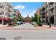 Scenic street view with shops and apartments, a prominent building at the end, and lush greenery at 2100 Willshire Gln, Alpharetta, GA 30009