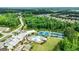 Aerial view showcasing community amenities like a pool and tennis courts surrounded by lush greenery at 123 Mulberry Ct, Peachtree City, GA 30269