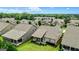 Aerial view of the home in a neighborhood, highlighting green lawns and backyard patios at 123 Mulberry Ct, Peachtree City, GA 30269