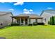 Manicured backyard features a covered patio and a well-maintained lawn for outdoor enjoyment at 123 Mulberry Ct, Peachtree City, GA 30269