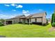 Backyard view of manicured lawn and covered patio, perfect for outdoor living at 123 Mulberry Ct, Peachtree City, GA 30269