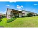 View of a home's manicured lawn with covered patio at 123 Mulberry Ct, Peachtree City, GA 30269