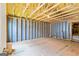 Spacious unfinished basement with studded walls and plywood flooring offers customization options at 123 Mulberry Ct, Peachtree City, GA 30269