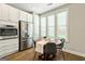 Cozy breakfast nook with a wooden table, stainless steel refrigerator, and natural lighting at 123 Mulberry Ct, Peachtree City, GA 30269