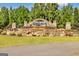Stone Cresswind community entrance sign with flower beds, lush landscaping, and a backdrop of mature trees at 123 Mulberry Ct, Peachtree City, GA 30269