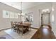 Charming dining area with rustic wooden table and views into the kitchen at 123 Mulberry Ct, Peachtree City, GA 30269