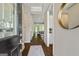 Inviting entryway with hardwood floors, decorative rug, and sight lines to the living room and kitchen at 123 Mulberry Ct, Peachtree City, GA 30269