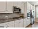 Bright kitchen with stainless appliances, tile backsplash, and ample storage at 123 Mulberry Ct, Peachtree City, GA 30269