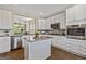 Stylish kitchen with white cabinetry, stainless steel appliances, and center island at 123 Mulberry Ct, Peachtree City, GA 30269