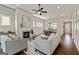 Spacious living room with a fireplace, ceiling fan, lots of seating, and an open layout at 123 Mulberry Ct, Peachtree City, GA 30269