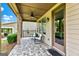 Covered patio with tile flooring, ceiling fan, and outdoor seating perfect for relaxation at 123 Mulberry Ct, Peachtree City, GA 30269