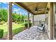 Inviting covered patio with ceiling fan, and stone tile flooring, ideal for outdoor entertaining at 123 Mulberry Ct, Peachtree City, GA 30269
