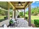 Covered outdoor patio with decorative tile, offering a relaxing seating area with scenic views at 123 Mulberry Ct, Peachtree City, GA 30269