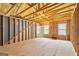 Unfinished room featuring wood framing, windows, and natural light at 123 Mulberry Ct, Peachtree City, GA 30269