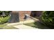 Backyard view, highlighting the utility connections behind the brick home at 2334 Connally Dr, East Point, GA 30344